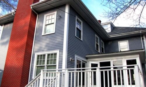 blue painted house and red brick chimney