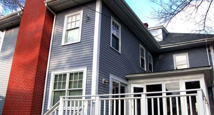 blue painted house and red brick chimney