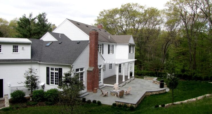 view from above of white house with large backyard and deck