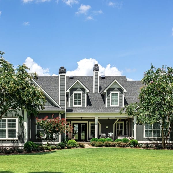 exterior house, blue skies, green grass and trees