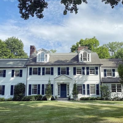 white mansion with blue shutters